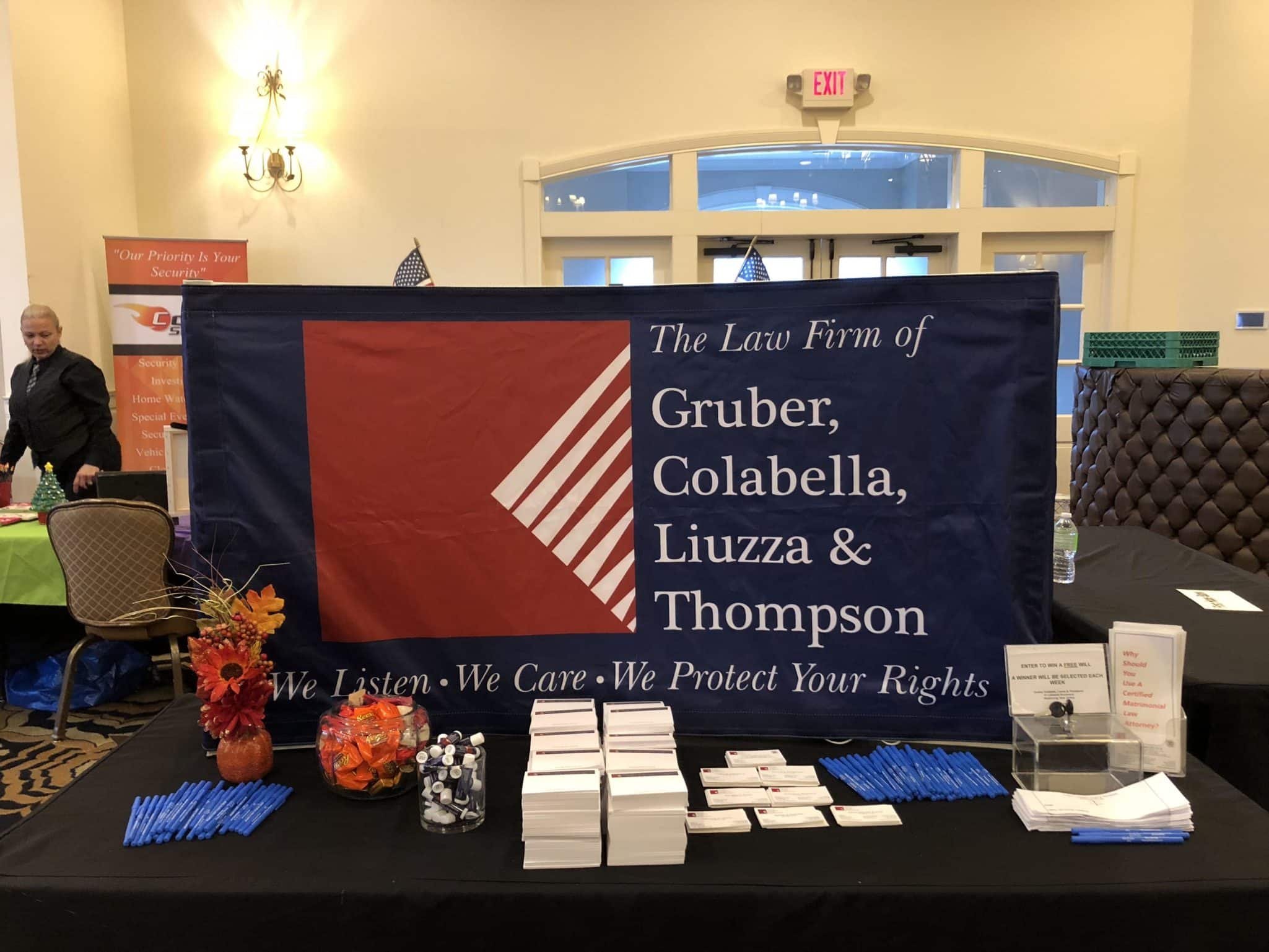 a presentation table with pens, forms, and business cards on display.