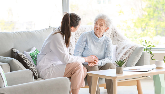 Doctor with senior woman in nursing home