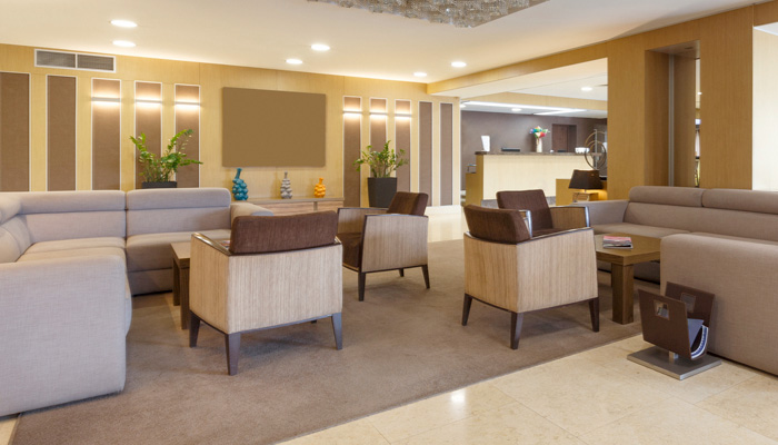 Gray sofas and armchairs in hotel lounge room
