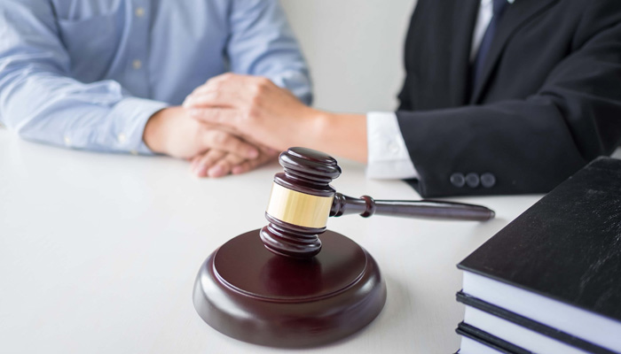 Judge gavel with lawyers advice legal at law firm in background. Concepts of law services
