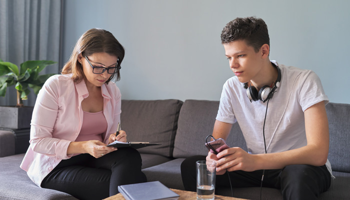 Teen boy talking to psychologist
