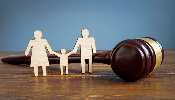 gavel with wooden family figurines