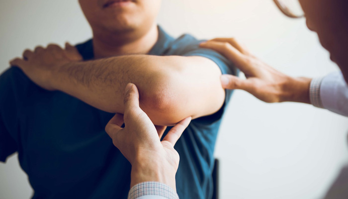 physical therapists are checking patients elbows at the clinic office room
