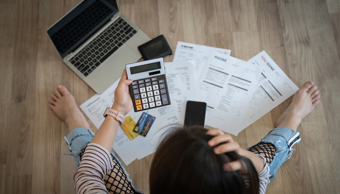 stressed woman trying money to pay credit card debt and many expenses bills