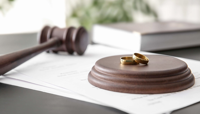wedding rings sitting on gavel stand