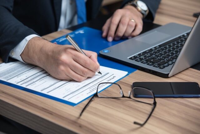 business man writing a contract