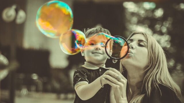 mother with child blowing bubbles